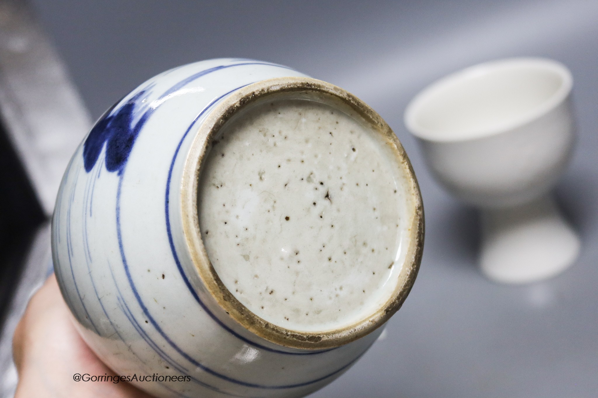 An 18th century Chinese blue and white bottle vase, together with a saucer and blanc de chine stem cup, 22cm